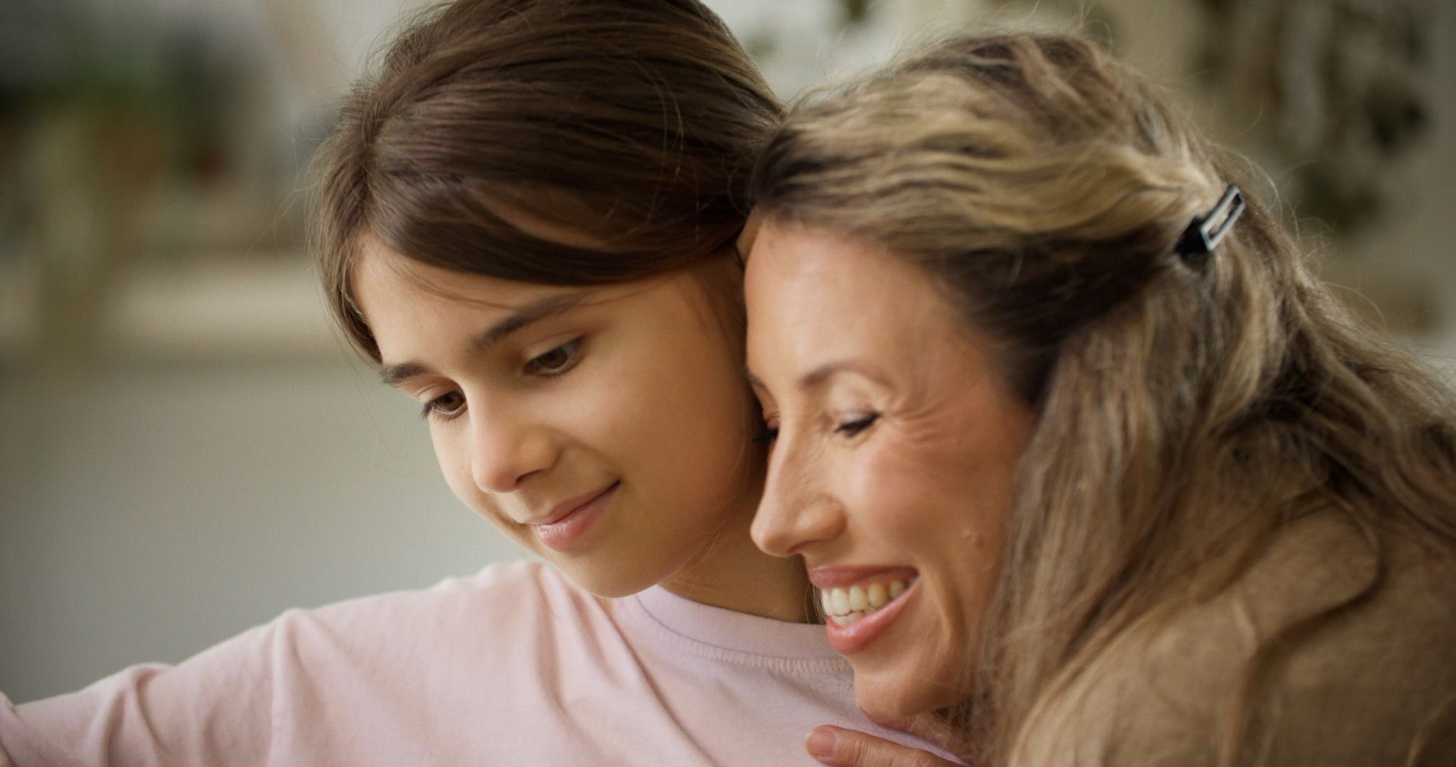 A mother and daughter sharing a warm moment together at home.