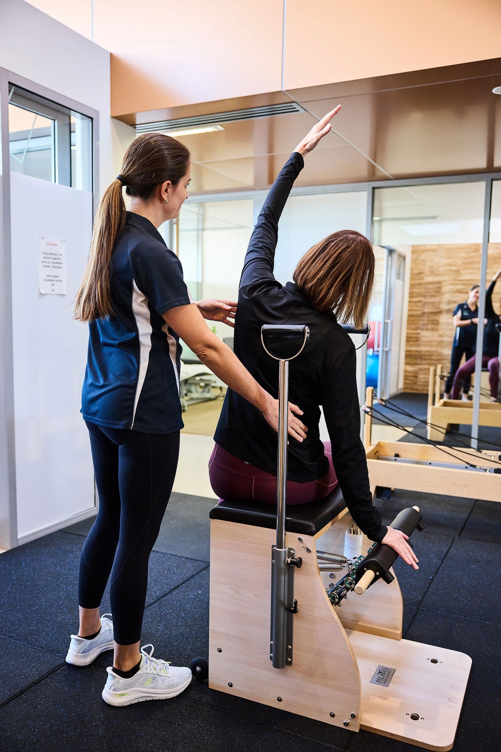 Clinical Pilates studio at Berrigan Physiotherapy with a physiotherapist guiding a client on the reformer