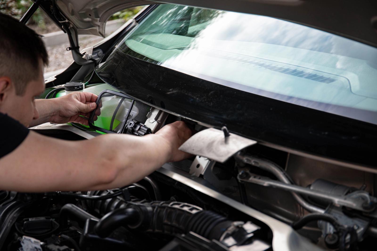 Mechanic working on a vehicle engine during car maintenance