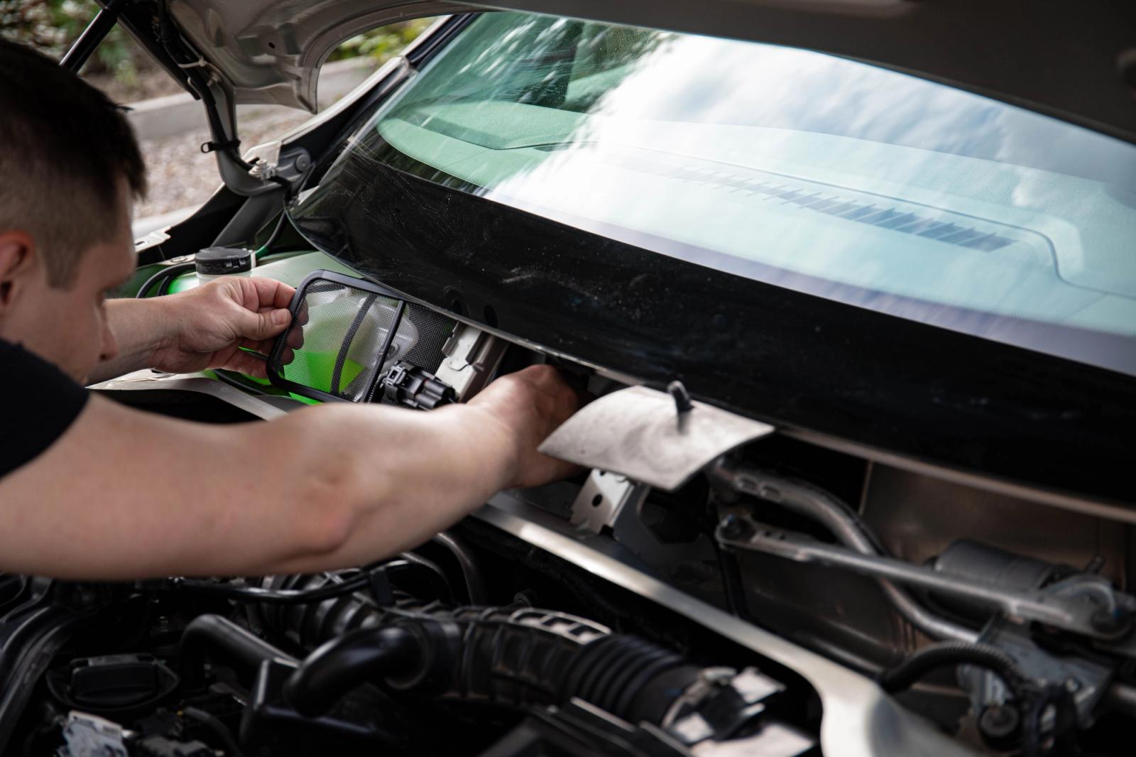 Mechanic working on a vehicle engine during car maintenance