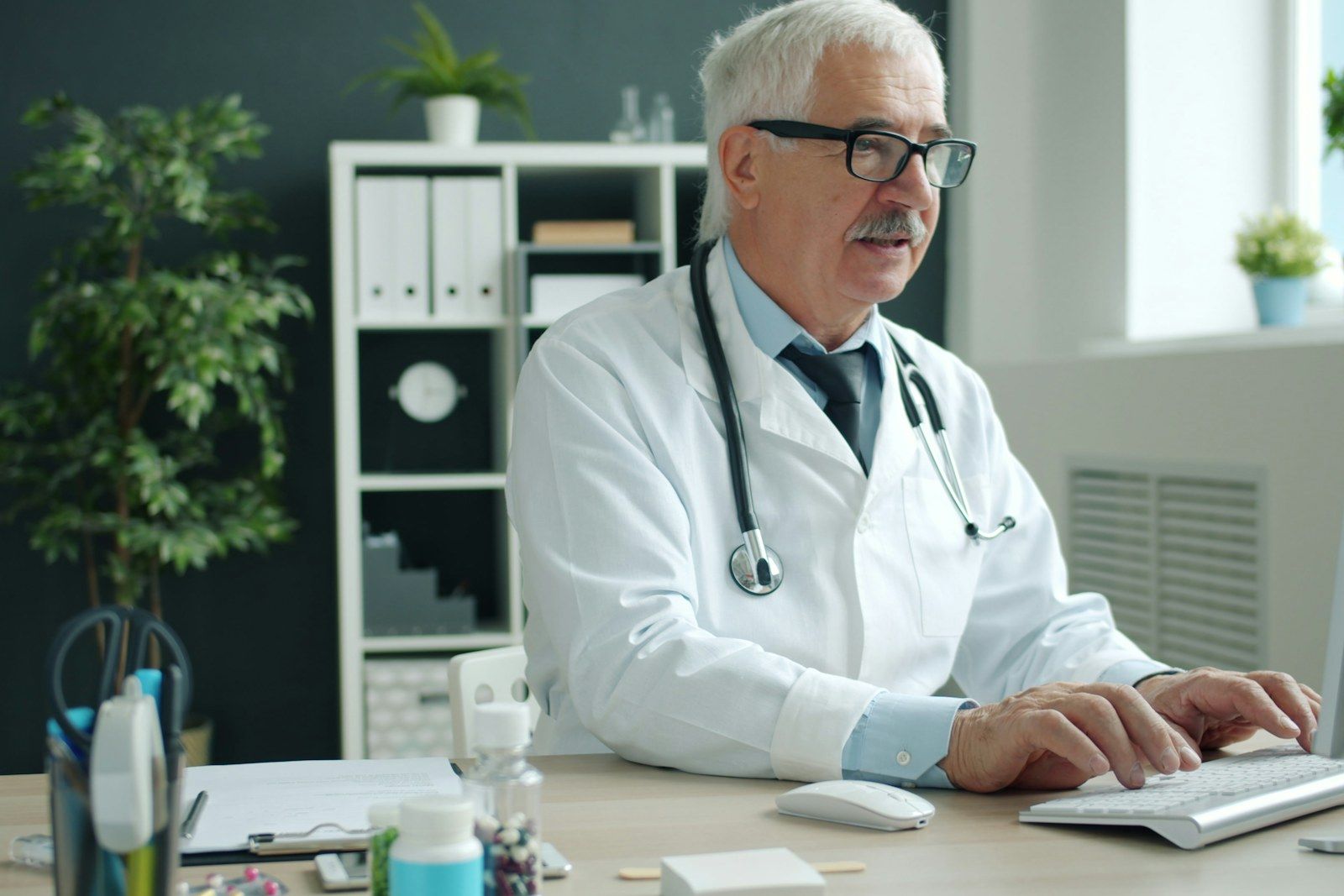 Doctor using a clinic computer to review online appointment availability