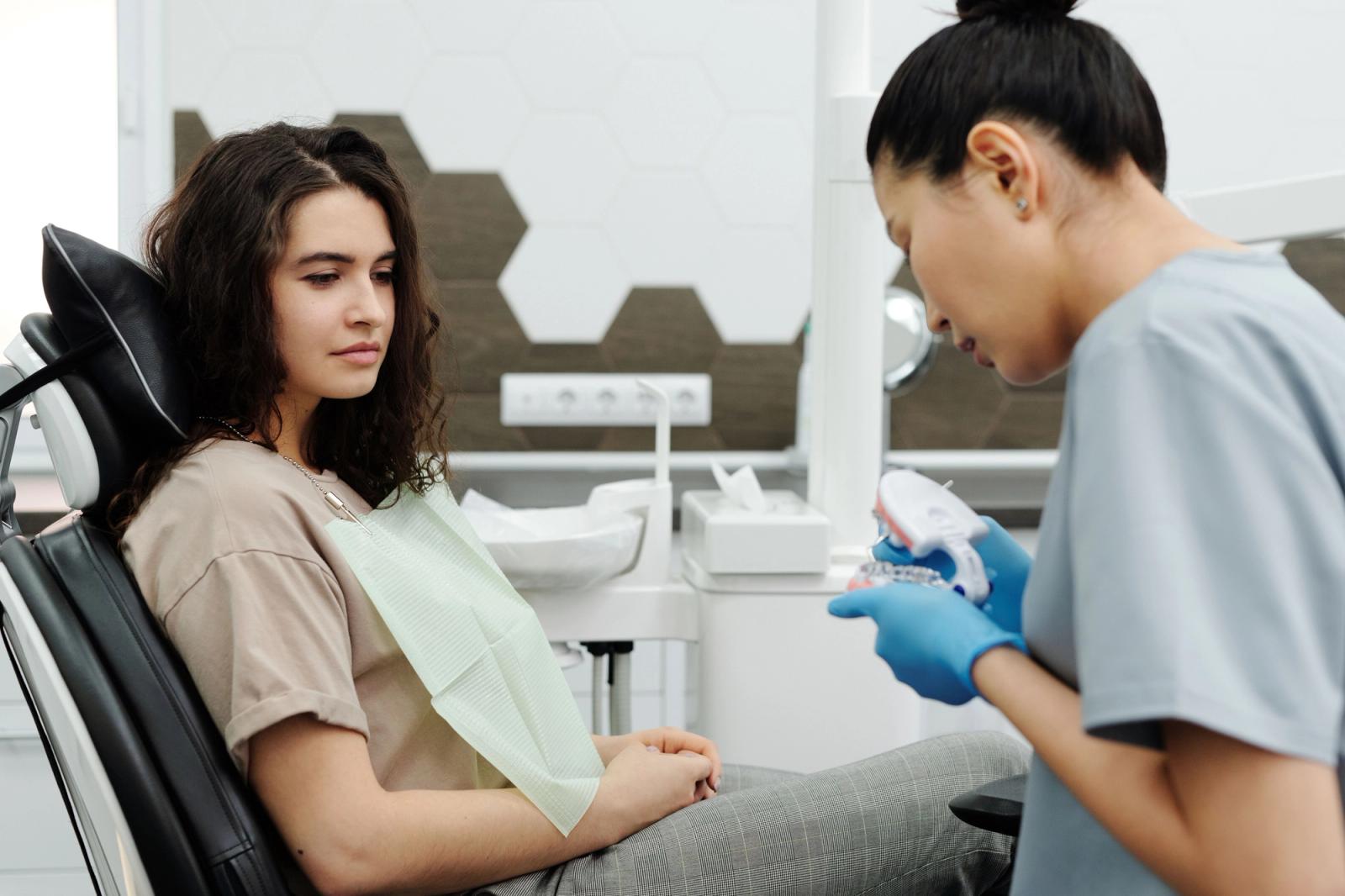 Dentist using a dental model during a patient consultation
