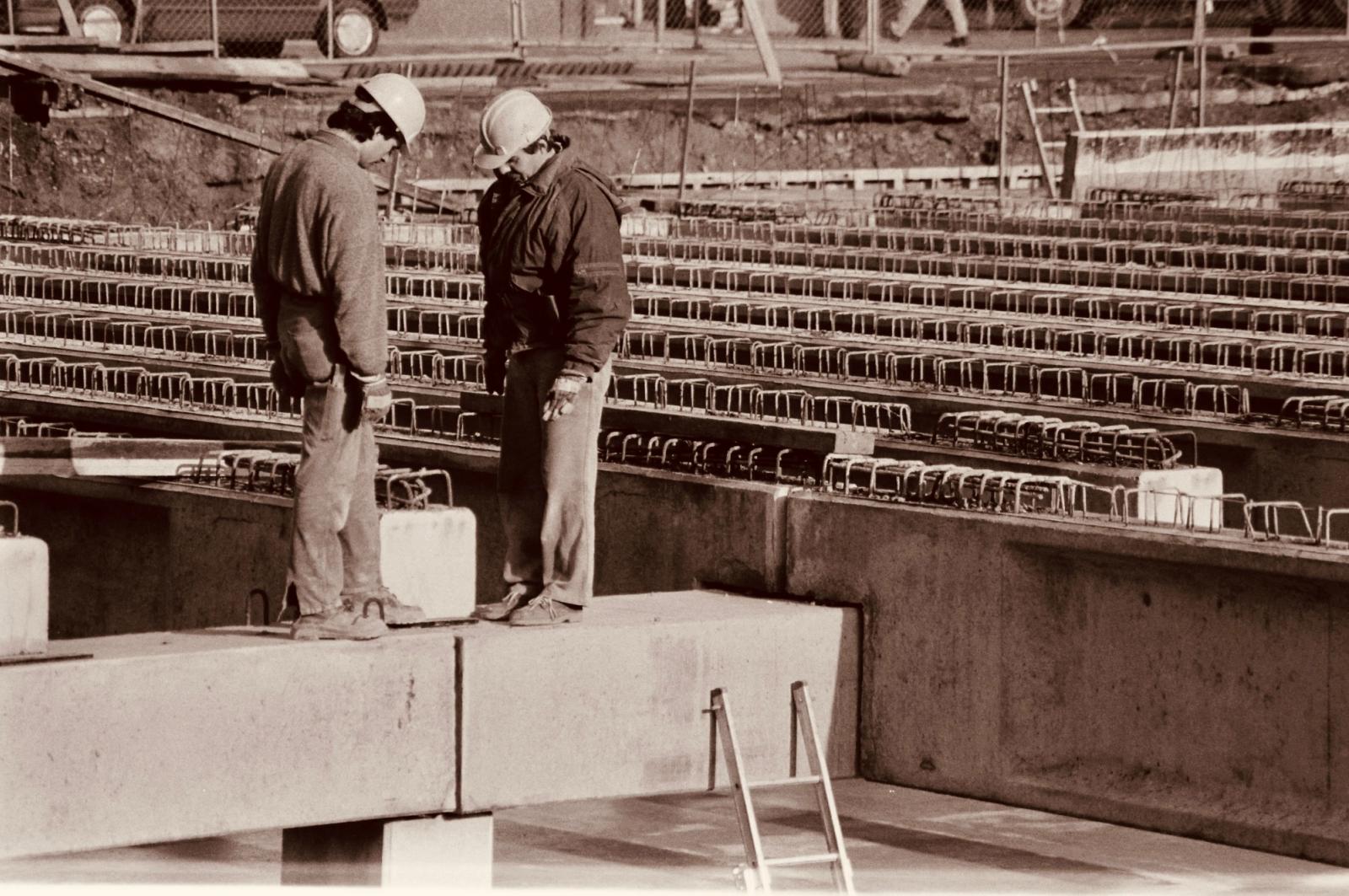 Two construction professionals reviewing plans together at a work site