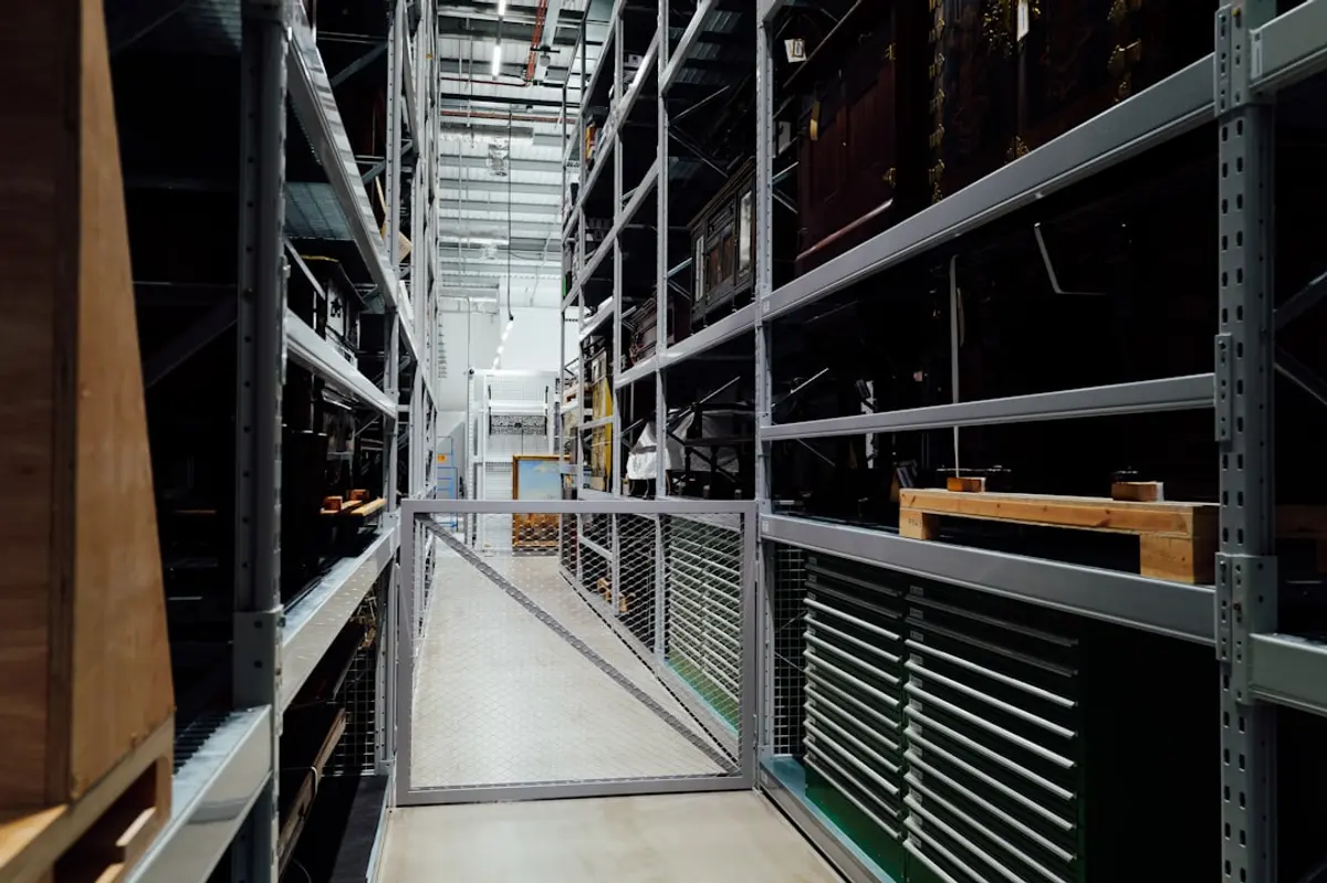 A long aisle between tall storage shelves in a warehouse.