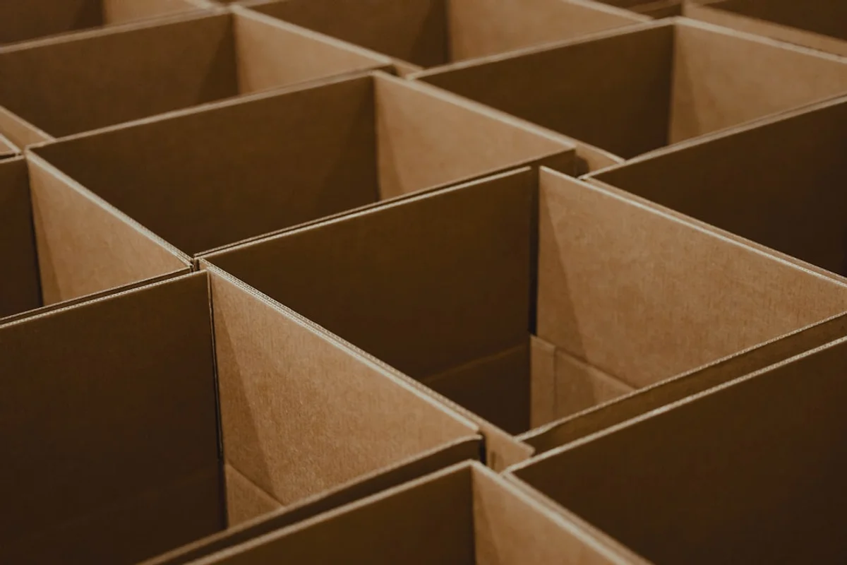 Open cardboard boxes arranged in a tight grid, seen from above