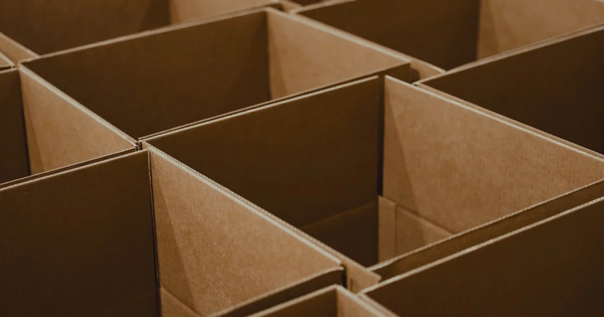 Open cardboard boxes arranged in a tight grid, seen from above