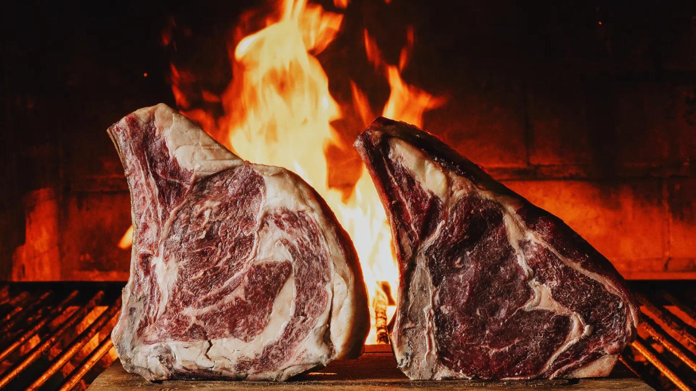 Grilled meat cooking at Carnal Steak House restaurant in Barcelona.