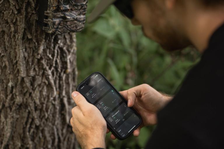 Hunter setting up a Y2 trail camera with the Command Center app