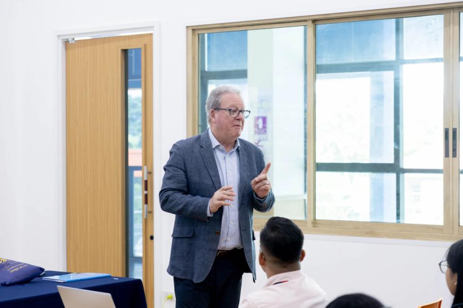 Mr Garry Chronican gestures while speaking to BCIS students during his presentation on study opportunities in New Zealand.