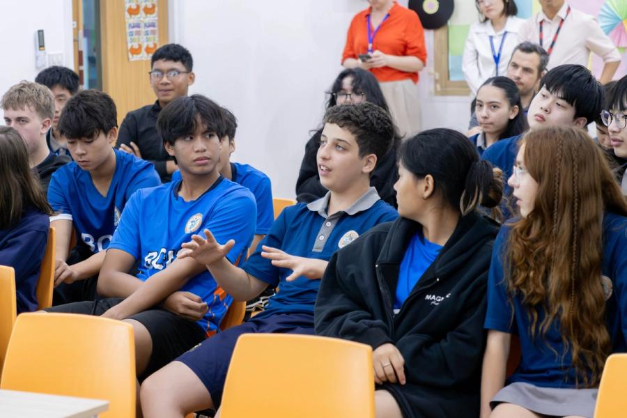 BCIS students in the audience discuss the presentation and prepare questions for the University of Otago's Director of Pathways.