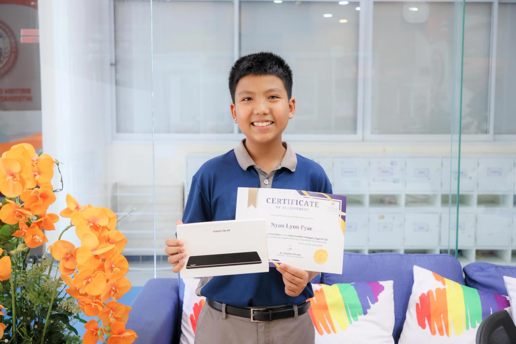 Ethan with his prizes and certificate at BCIS
