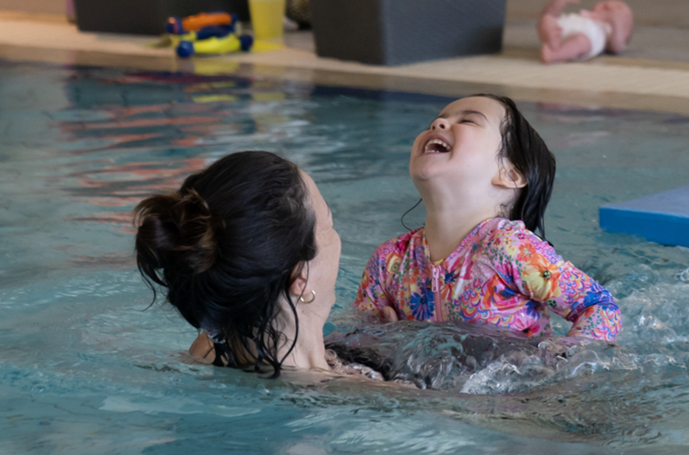 mother and a daughter in the pool 