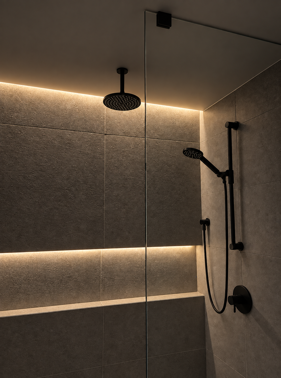 A modern bathroom with generous recessed niches, dark fixtures, and coordinated tile and stone finishes.
