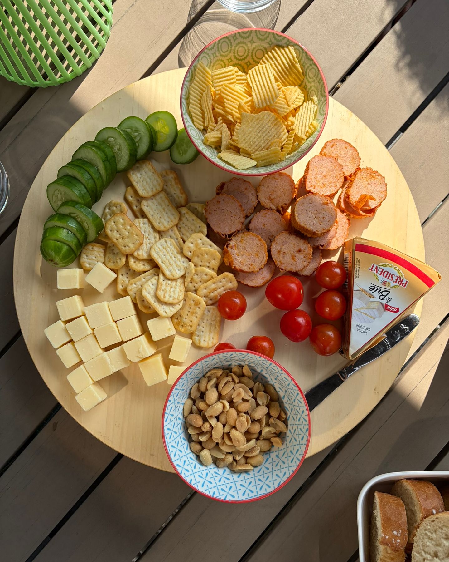 Borrelplank voor Franse apéro met kaas, brie, worst, komkommer, tomaat, stokbrood, chips en nootjes