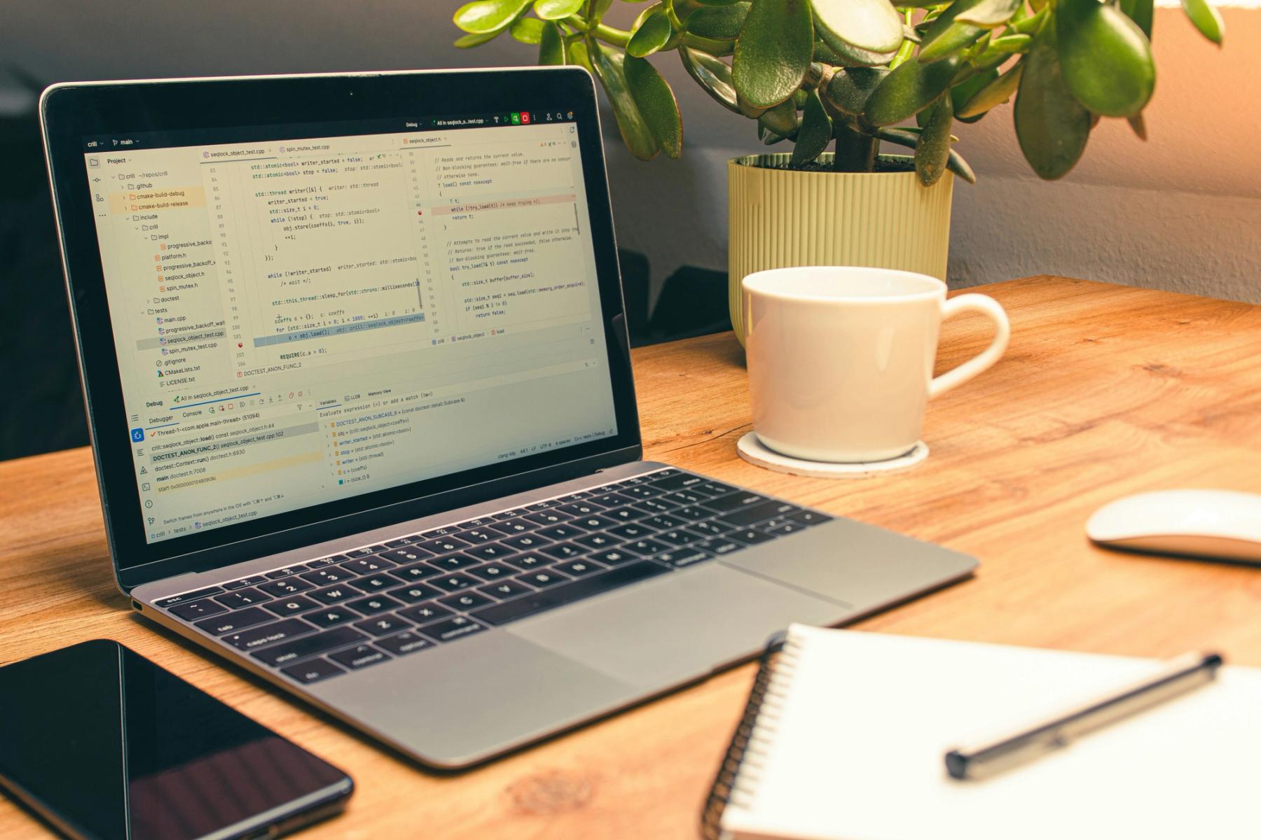 Laptop displaying website code on screen in a modern workspace, representing AI-assisted website development and the process of bringing a website online.