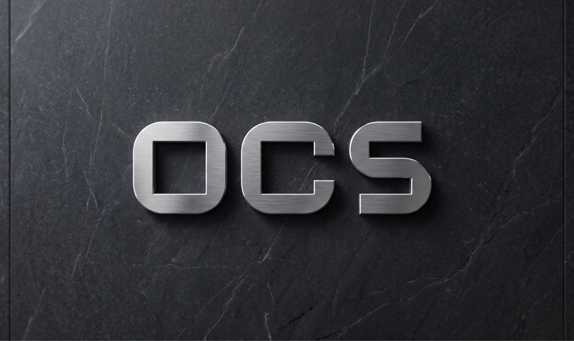 شعار OCS معدنياً على سطح حجري داكن
