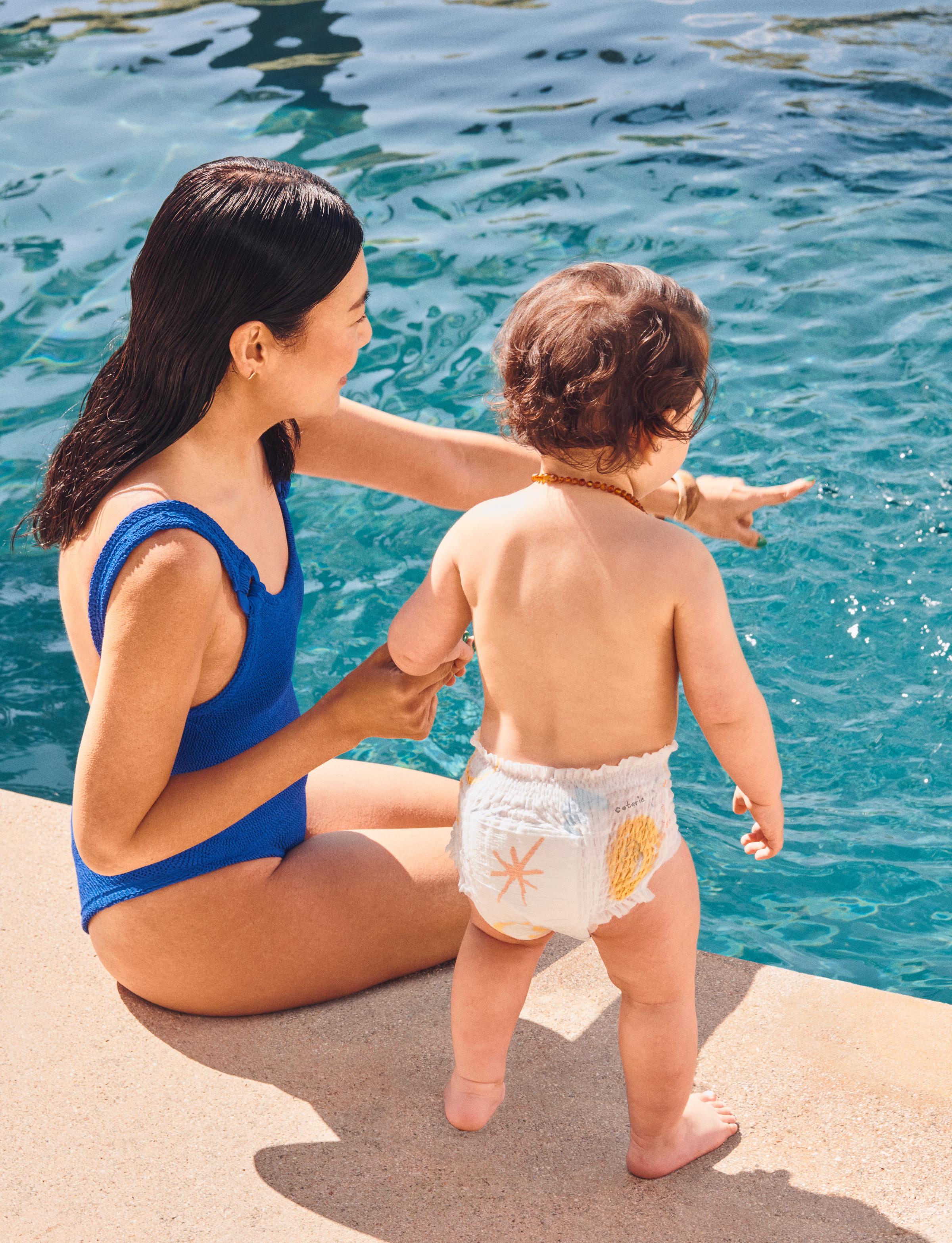 A woman and baby by a pool