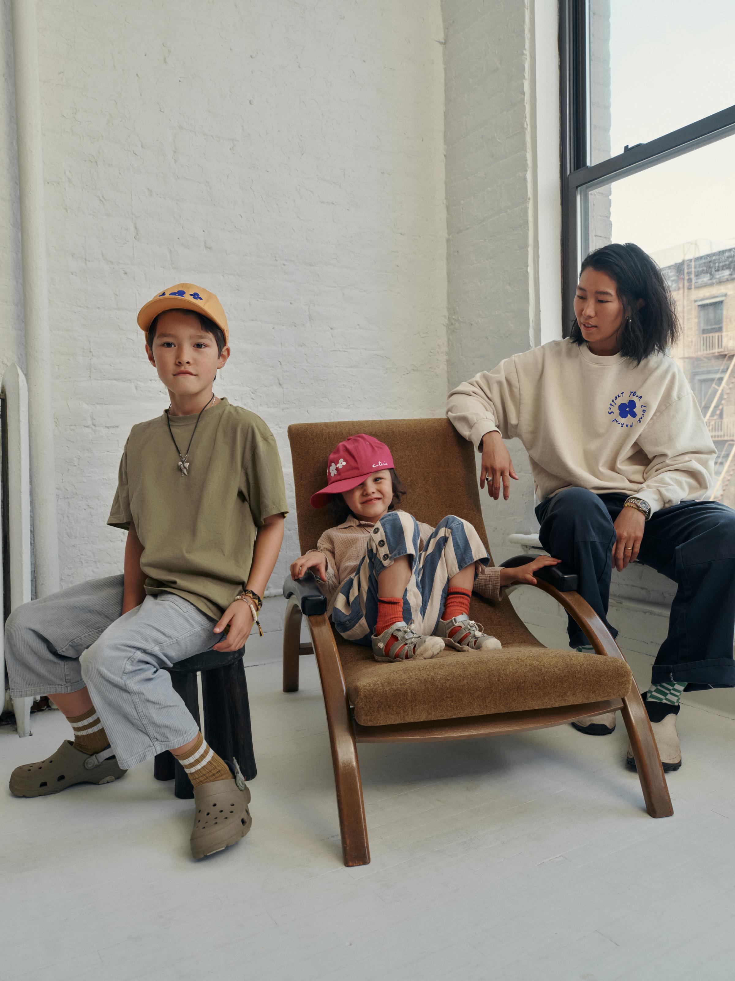 A mother and her two kids lounge in SYLP merch.