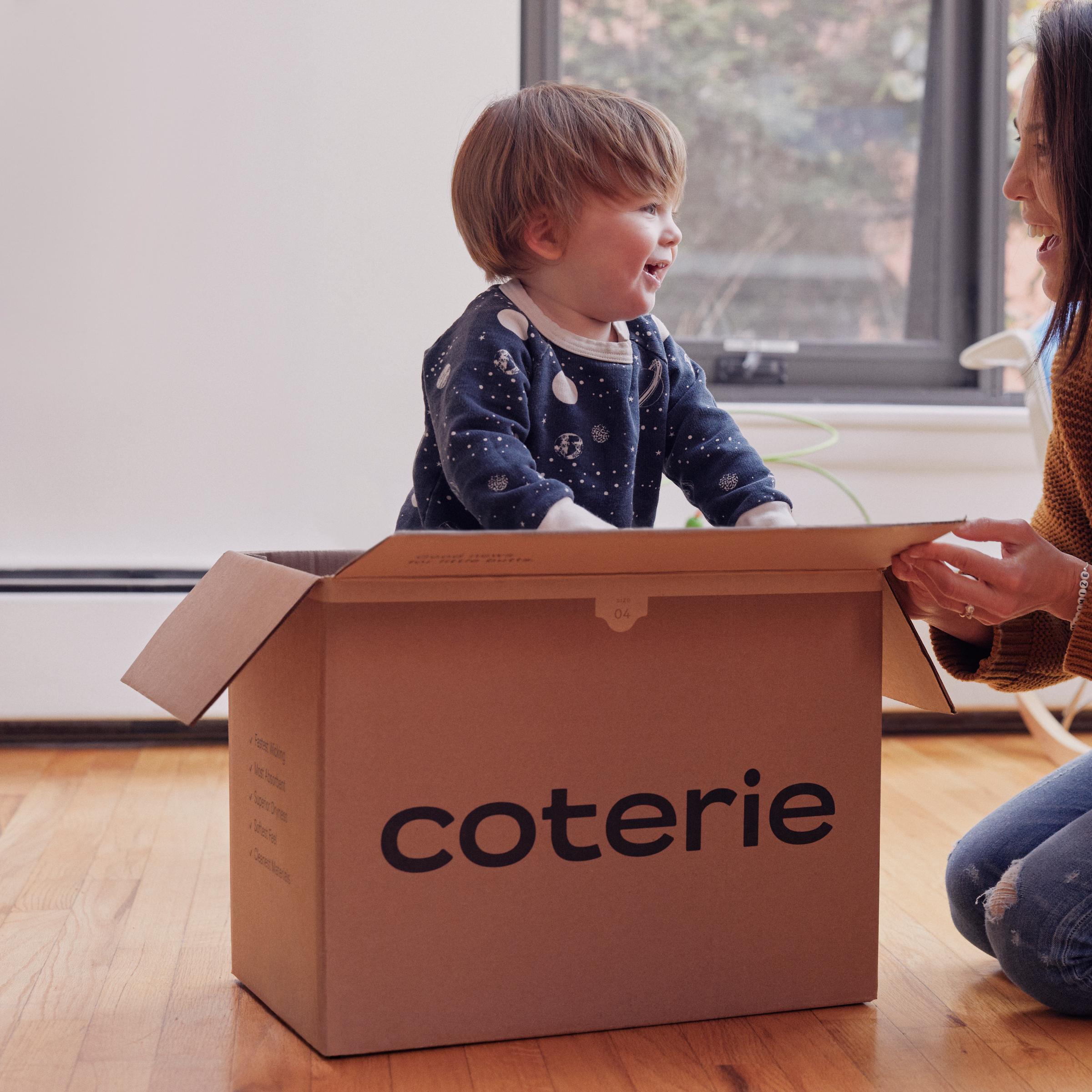 A child playing in a Coterie box.