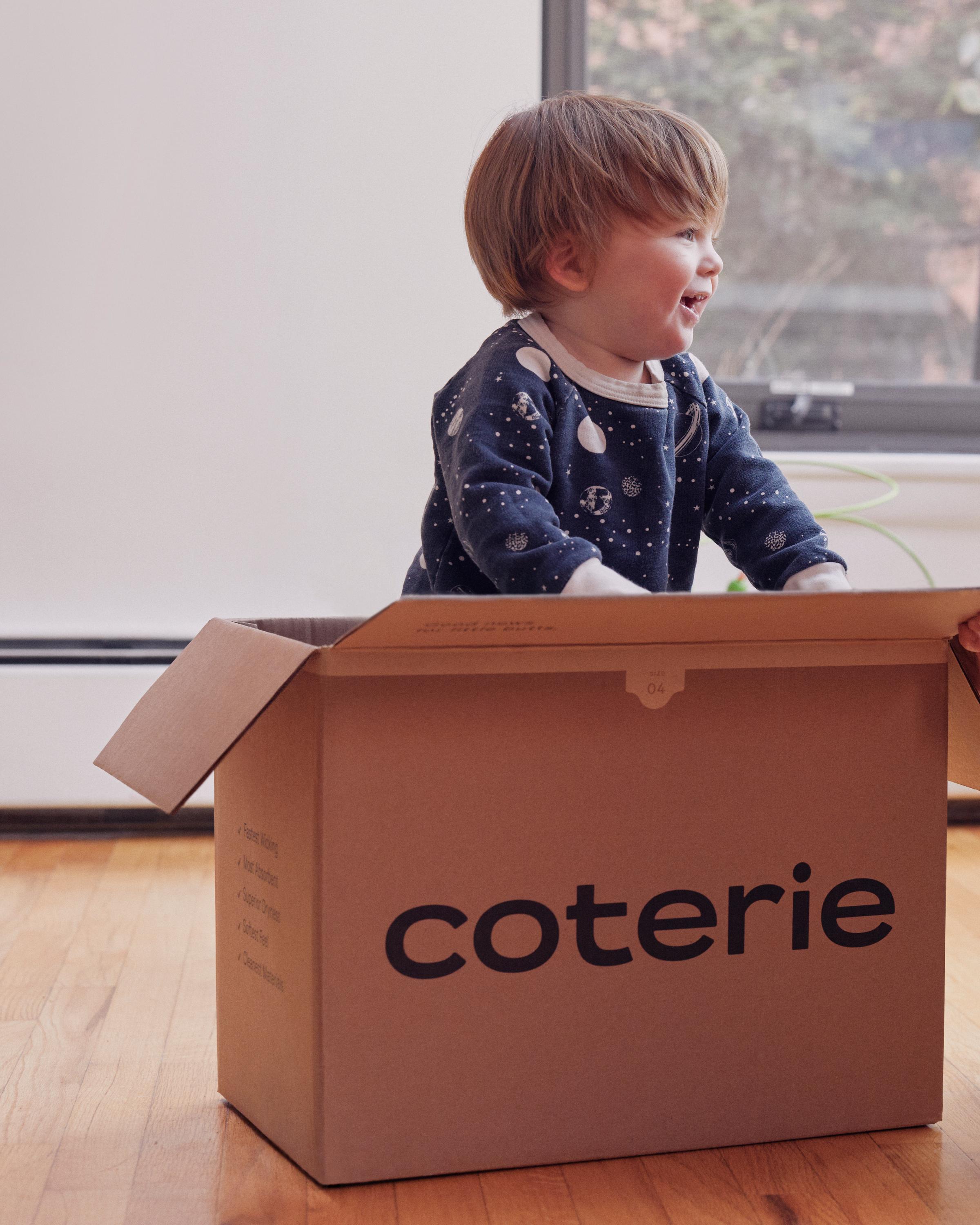 A child playing in a Coterie box.