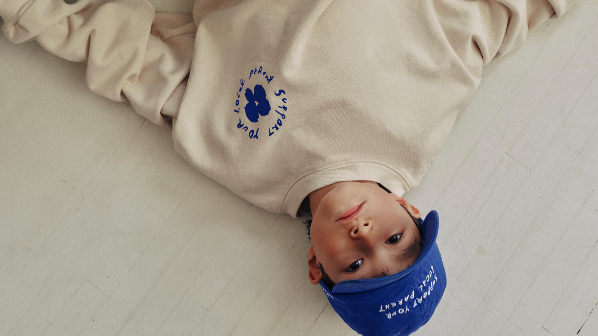 A child wearing Coterie "Support Your Local Parent" merch.