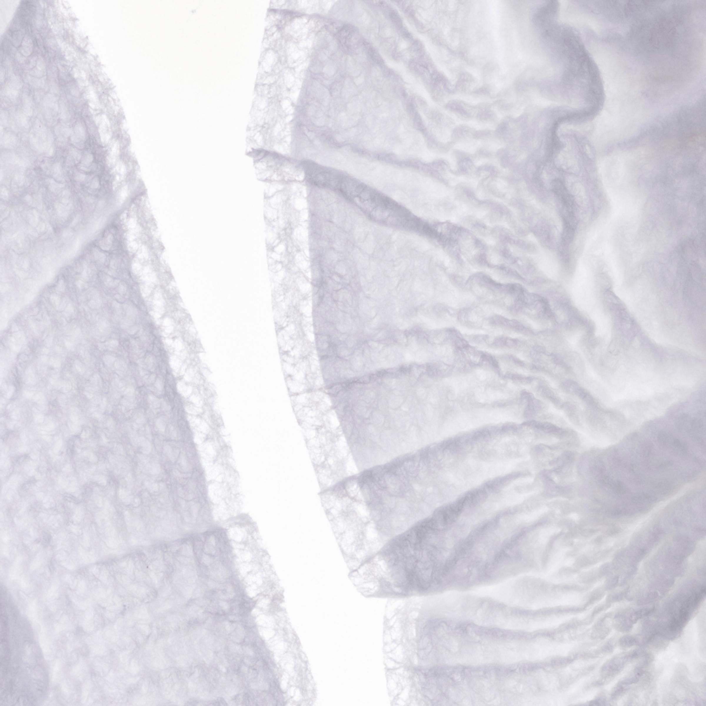 A close up image of a Coterie diaper that shows fine details such as texture, color and softness.