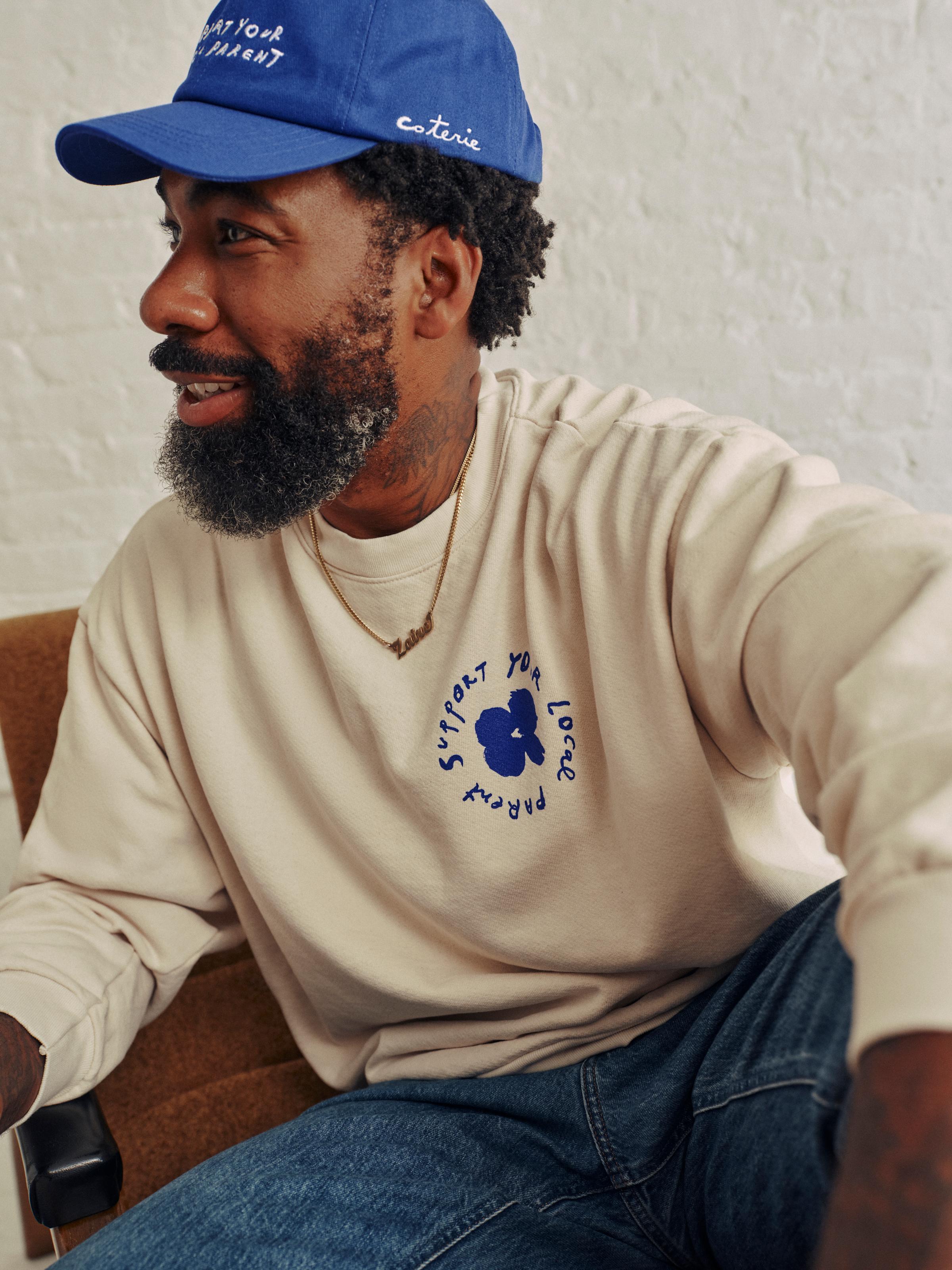 Rodney wearing the SYLP classic cap and crewneck.