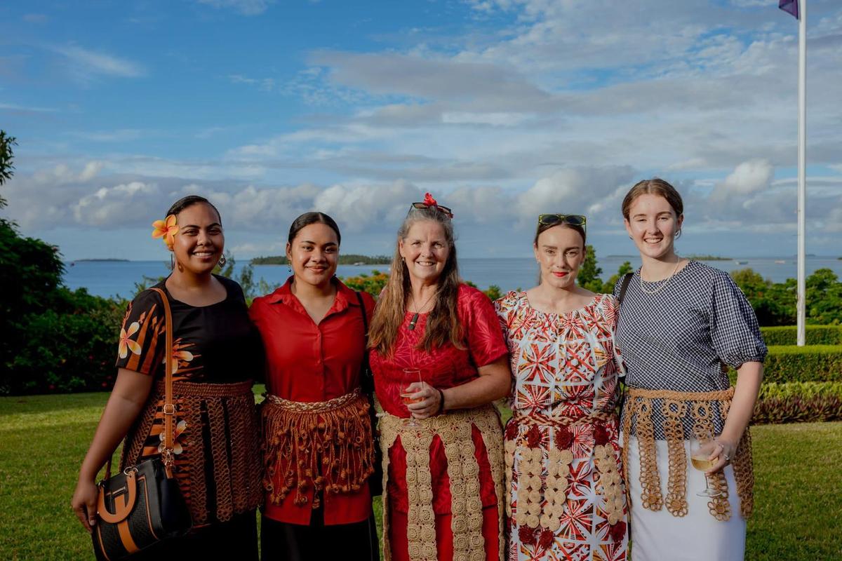 Group of five women smile for the camera