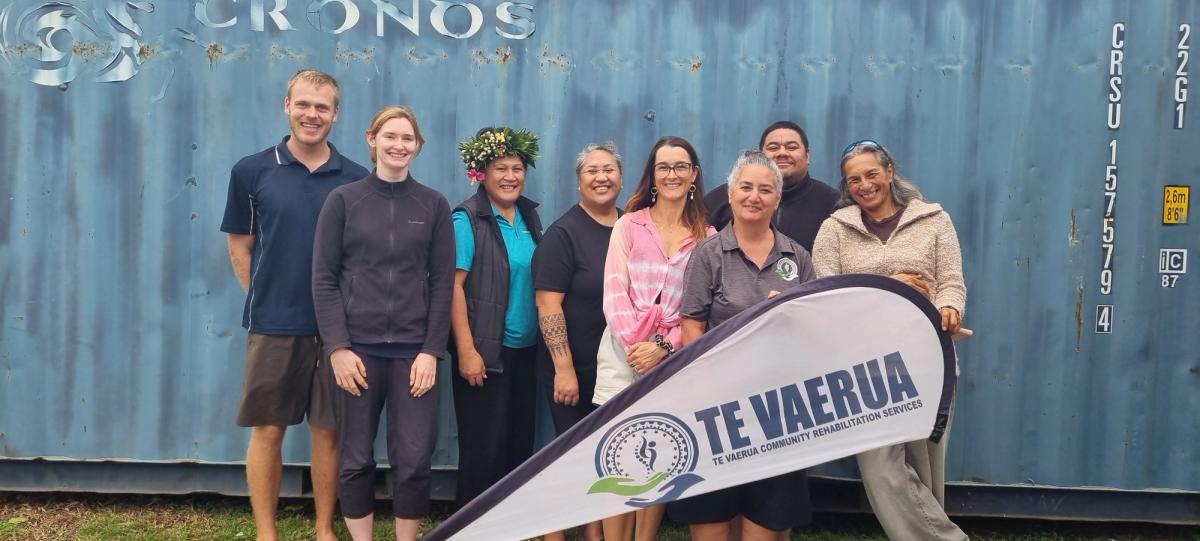 A group of people smiling for the camera A group of people smiling for the camera