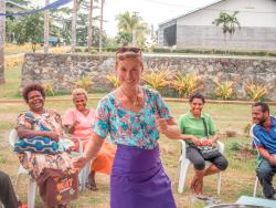 a woman is dancing in front of a group of people sitting in chairs . a woman is dancing in front of a group of people sitting in chairs .