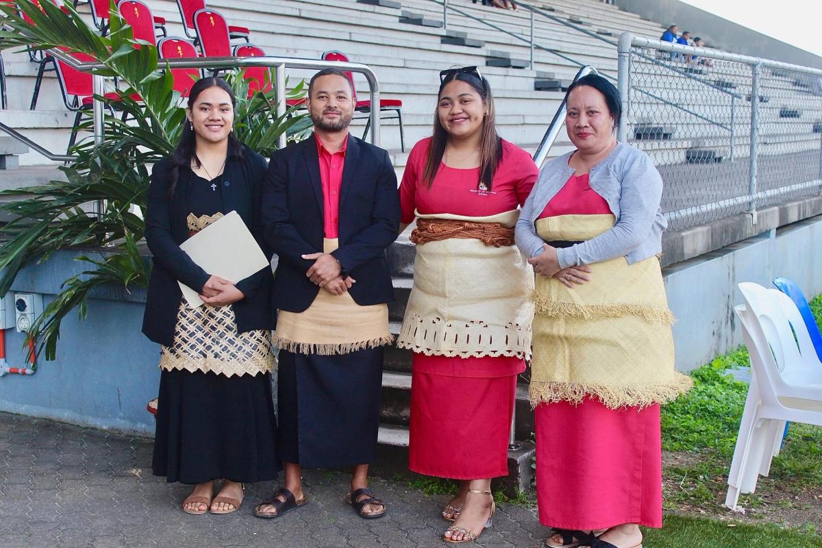 A group of people standing in a stadium and smiling for the camera