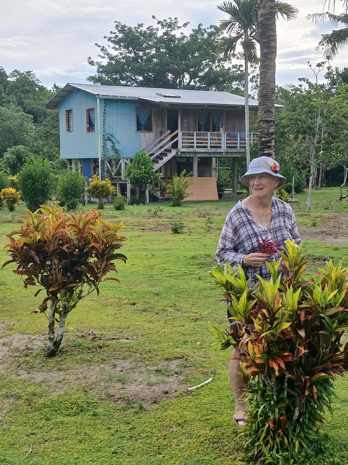 A woman standing in the front yard of a home