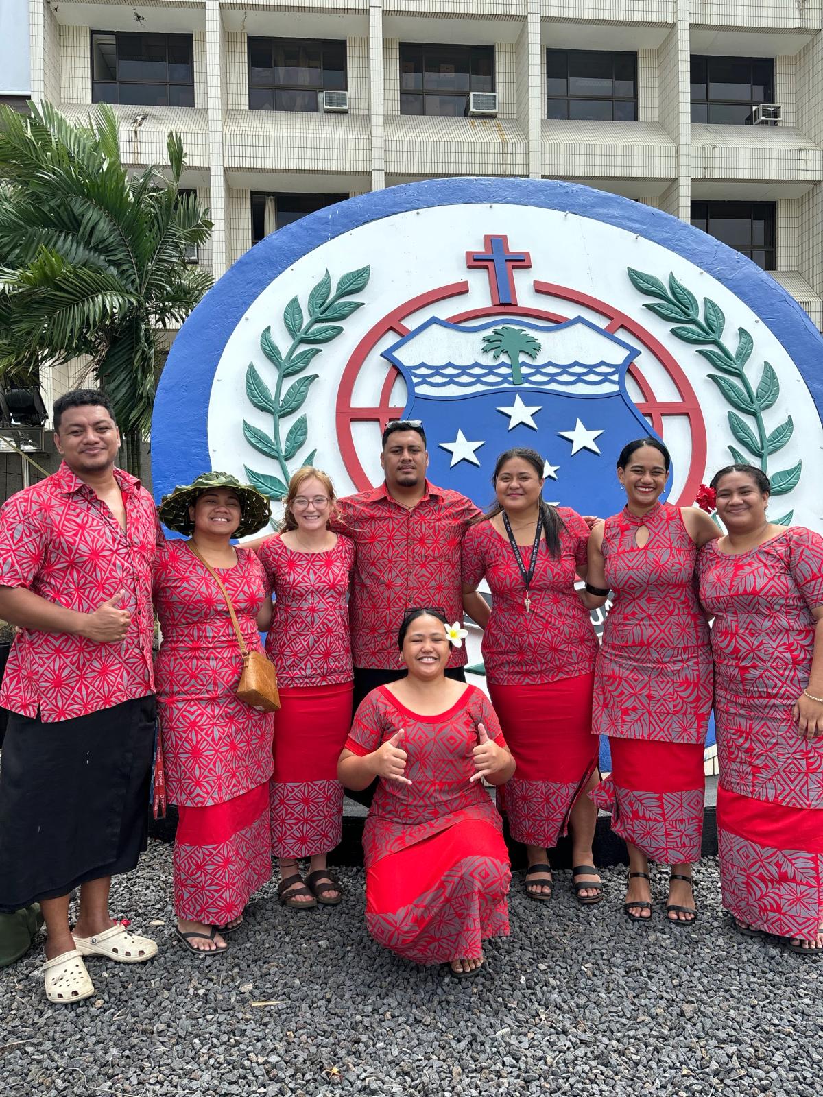 A group of people smile for the camera A group of people smile for the camera