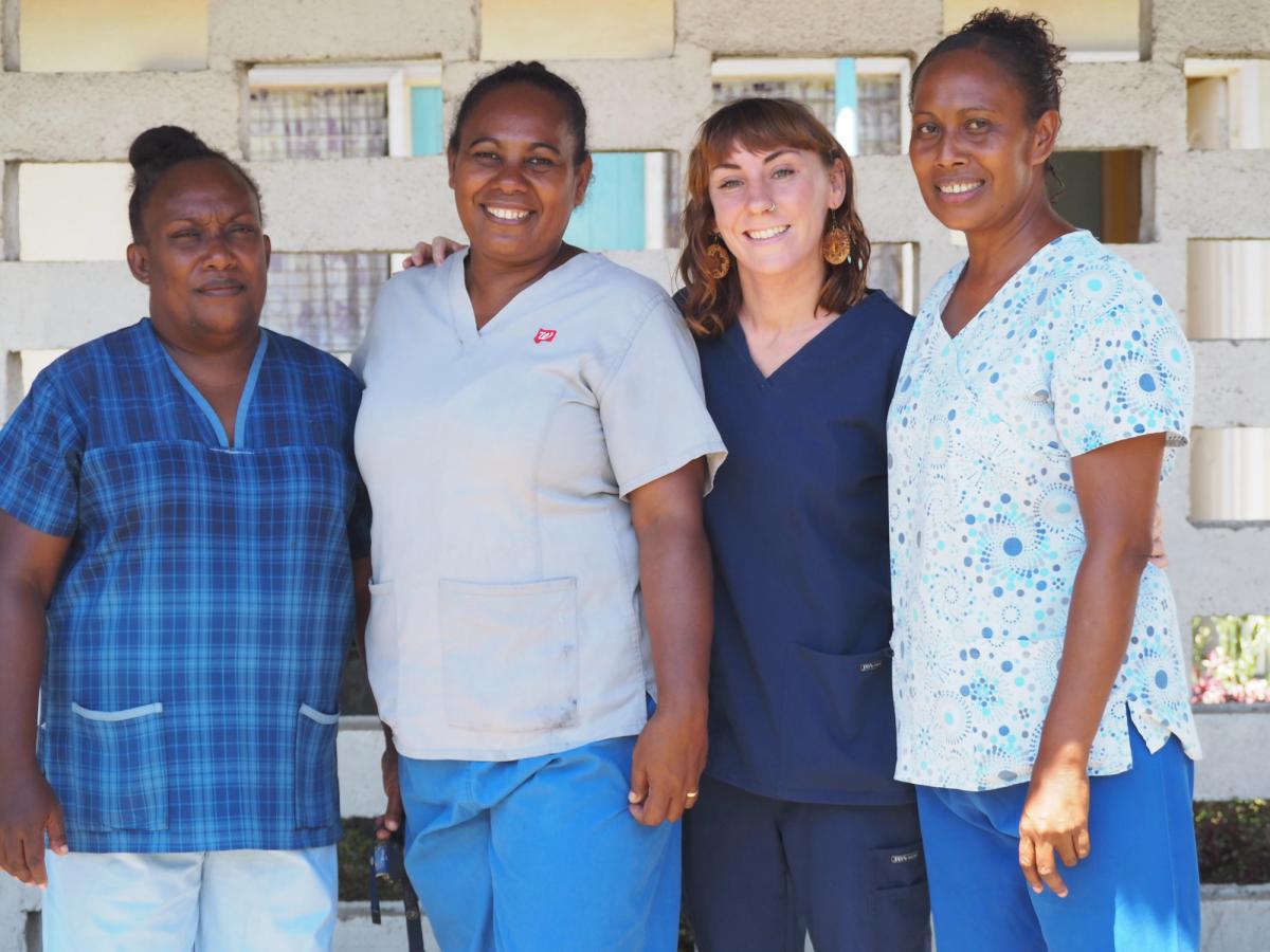 Four women smiling for the camera