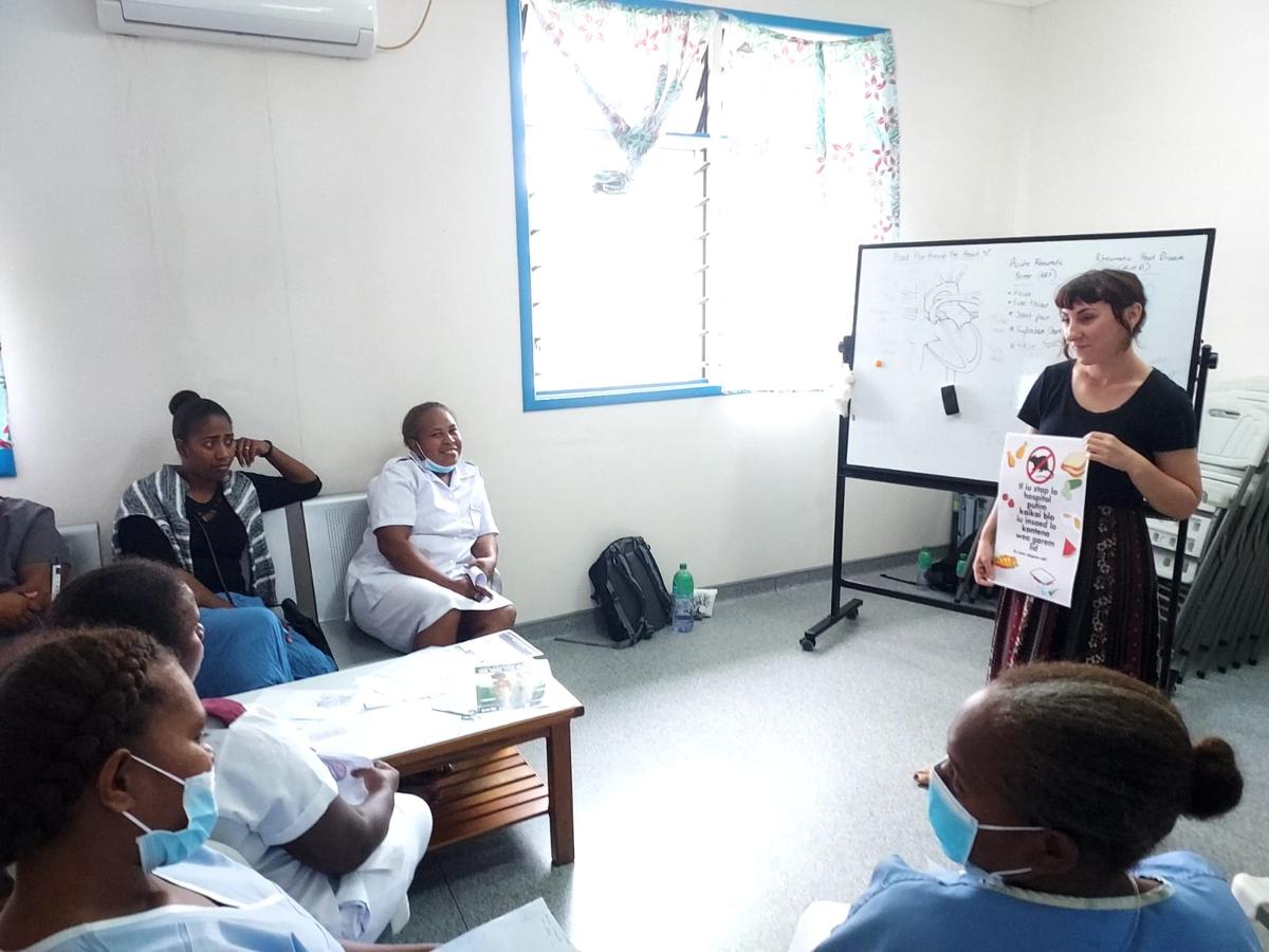 A woman presenting to a room of other women