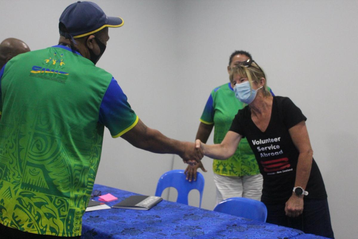 A man greets a woman with a handshake A man greets a woman with a handshake