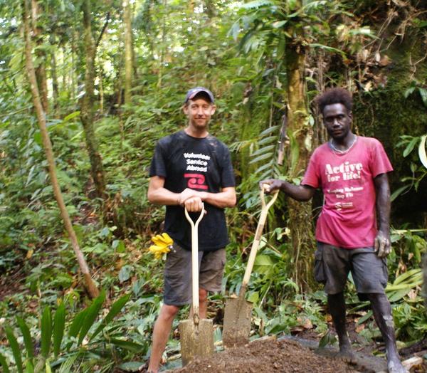 Two men holding shovels in the bush Two men holding shovels in the bush