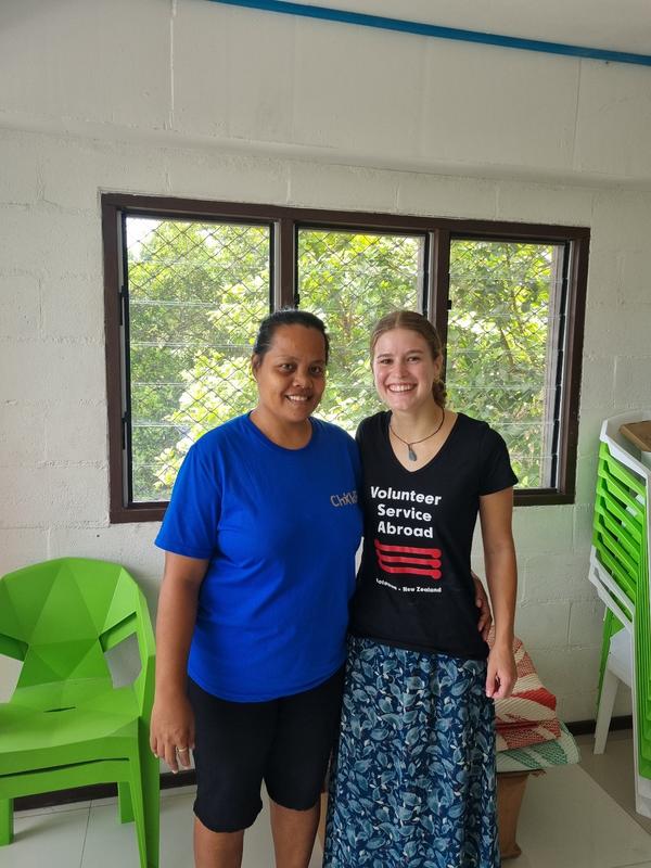 Two women standing side by side and smiling for the camera Two women standing side by side and smiling for the camera