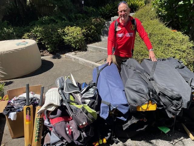 Mark stands over a pile of cricket gear that has been donated Mark stands over a pile of cricket gear that has been donated