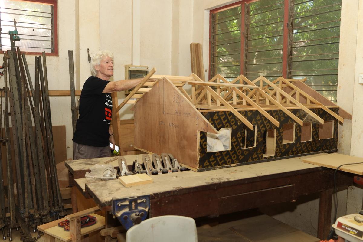 A man working on a building model.