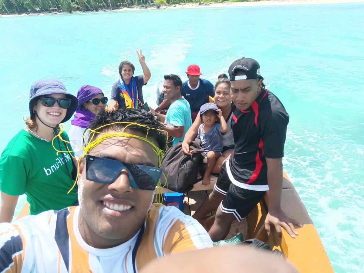 A group of people on a boat and smiling for a selfie
