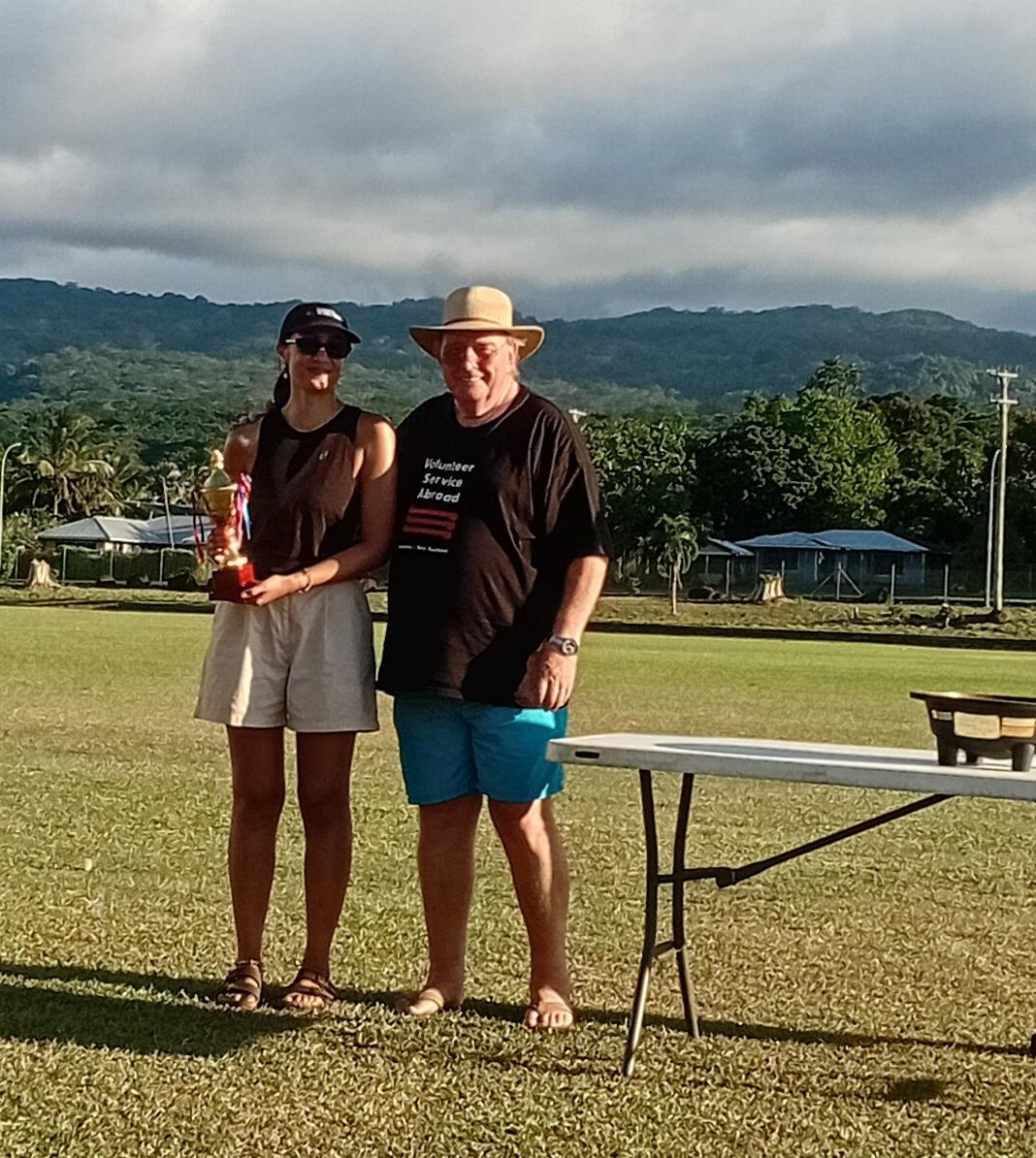 Two people on a field smiling at the camera. Two people on a field smiling at the camera.