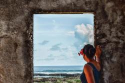a woman is dancing in front of a group of people sitting in chairs . a woman is dancing in front of a group of people sitting in chairs .