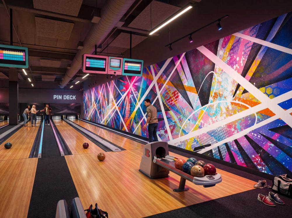 an interior photo of a bowling alley with an abstract wallpaper mural on the side wall
