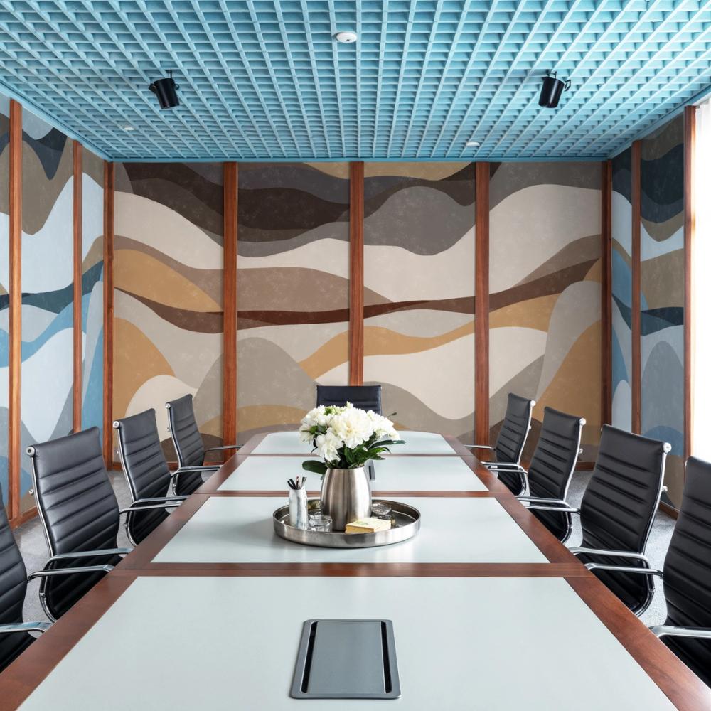 An interior photo of a board meeting room with an abstract wallpaper mural on the wall