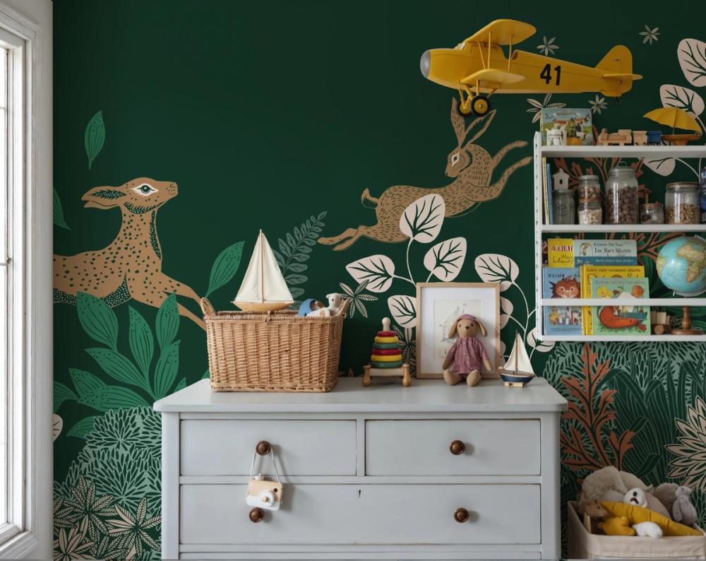 a photo of a dresser in a kids room with toys and shelf agains a dark green wallpaper with a jumping deer