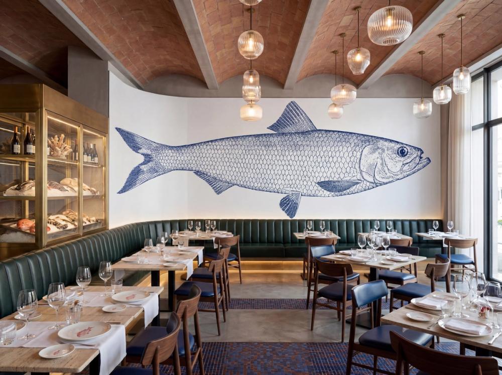 an interior photo of a mediterranean restaurant with a large blue fish wall mural