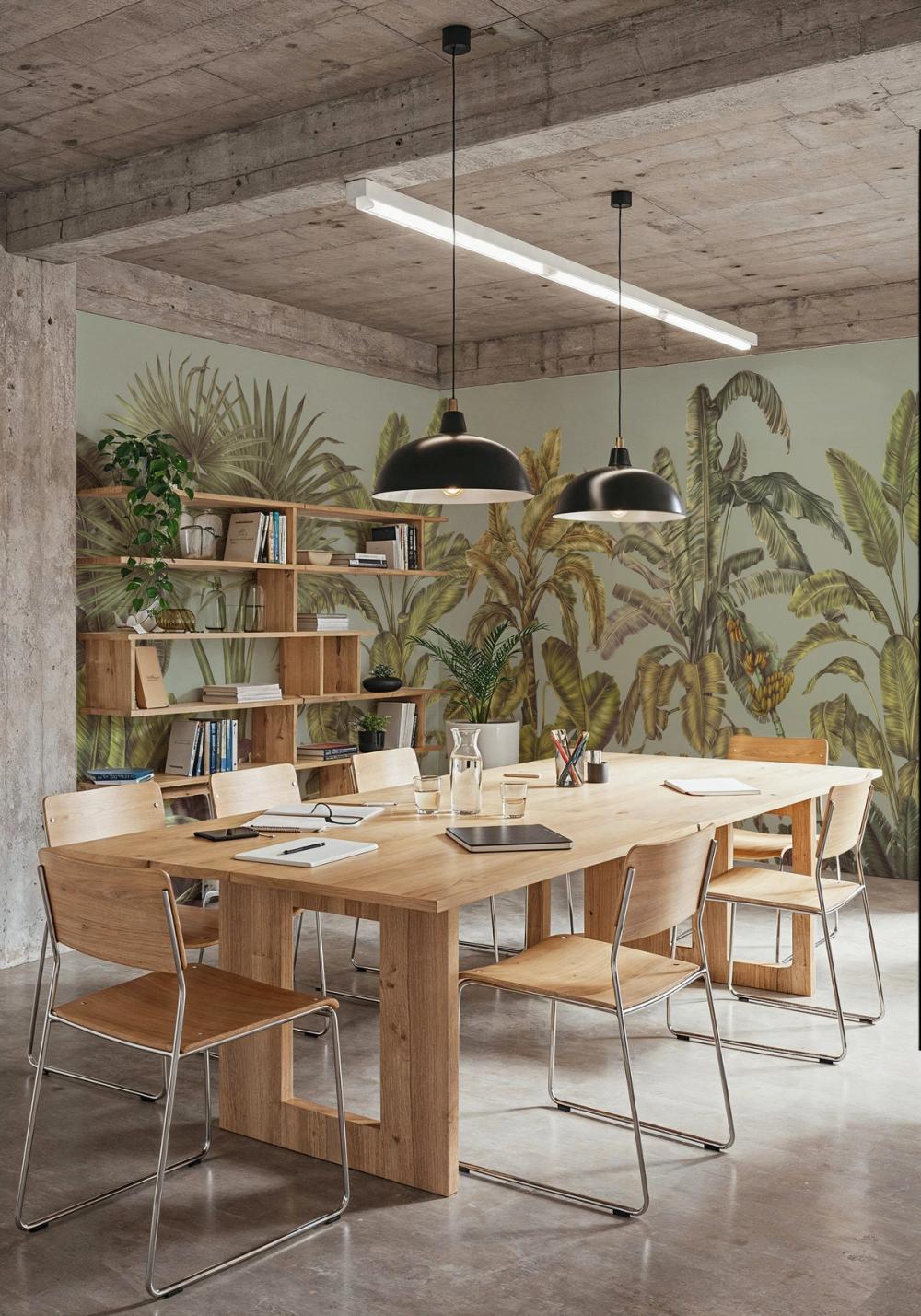an interior photo of an office meeting room with a jungle themed wallpaper mural on the wall