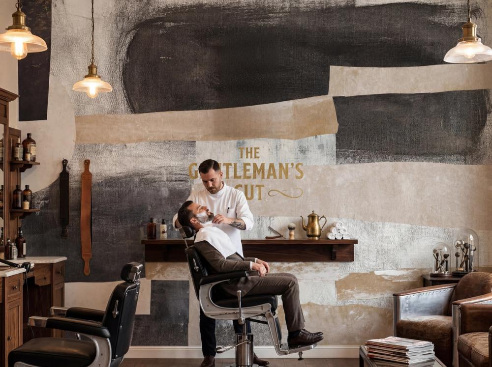 an interior photo of a classic barber shop with an abstract wallpaper mural on the wall