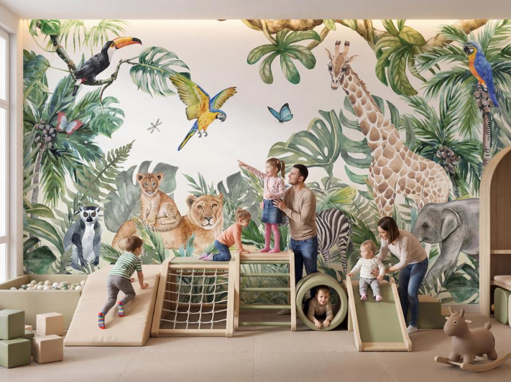 an interior photo of an indoor playground with a jungle themed wallpaper mural on the wall and kids playing
